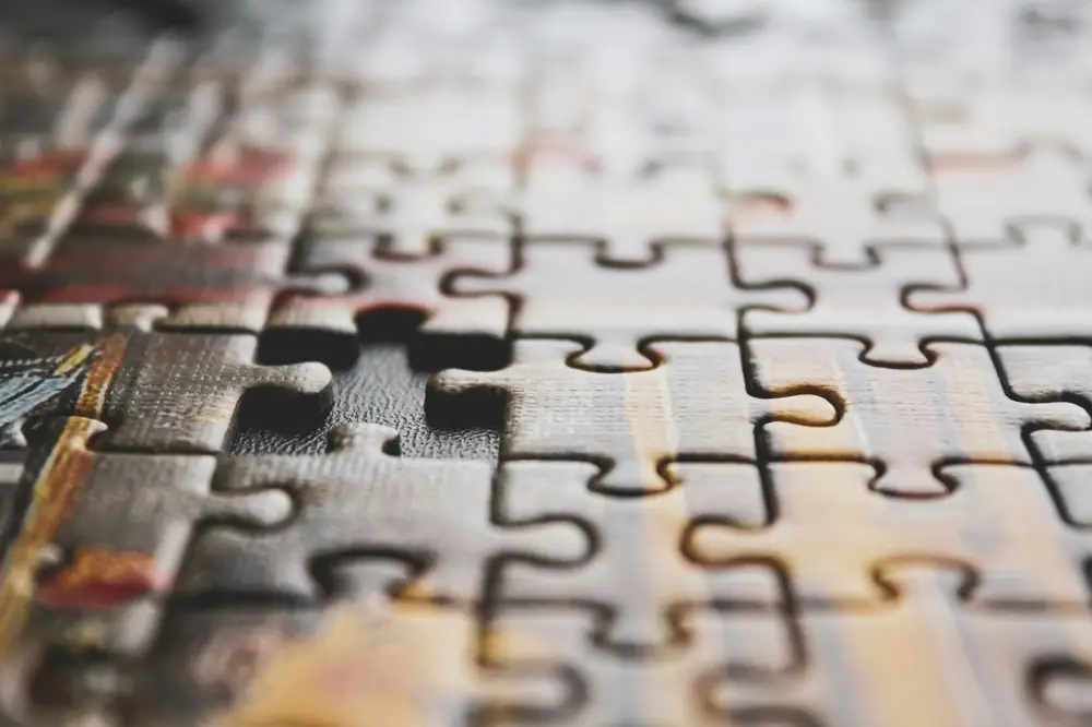 Close-up of a jigsaw puzzle with one piece still missing